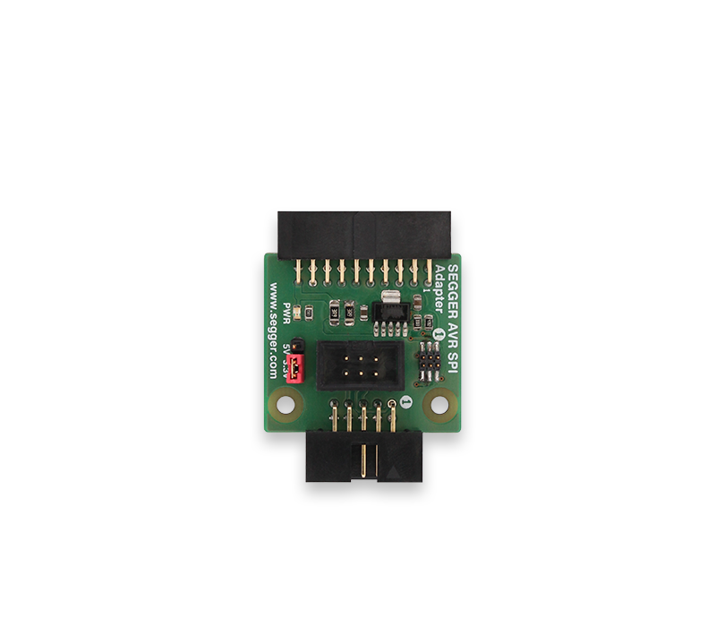 Image of a SEGGER AVR SPI adapter featuring a green circuit board with various electronic components, connectors, and pins. The adapter is typically used for programming and debugging AVR microcontrollers. The design includes labels for power and signal pins.